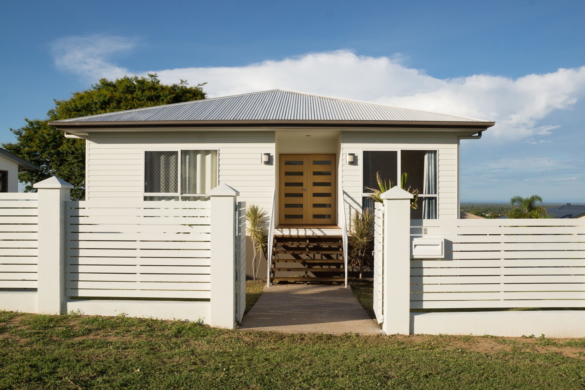 New modern contemporary house exterior with fence and front door